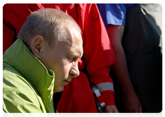 Vladimir Putin in control of the efforts to fasten the transmitter to the whale