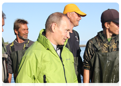 Владимир Путин и рыбаки смотрят вслед уплывающей Даше
