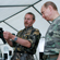 Professor Rozhnov showing Vladimir Putin an air rifle which scientists use to immobilise tigers