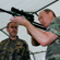 Vladimir Putin is particularly interested in the air rifle, and so he takes it and tries to aim