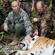 Vladimir Putin, Sergei Shoigu and the researchers having their photograph taken with the tigress