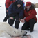 Vladimir Putin helping the researchers weigh the bear that has been caught and take all the necessary measurements and tests