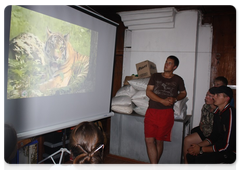 Students watch a film about the Amur tiger