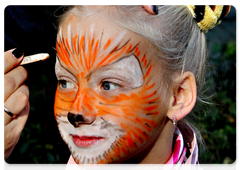 A participant in a carnival procession on Tiger Day