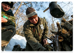 During long walks across the taiga, the counters stop to warm up by bonfires