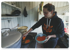 Student Darya Kisilenko cooking breakfast for her camp mates